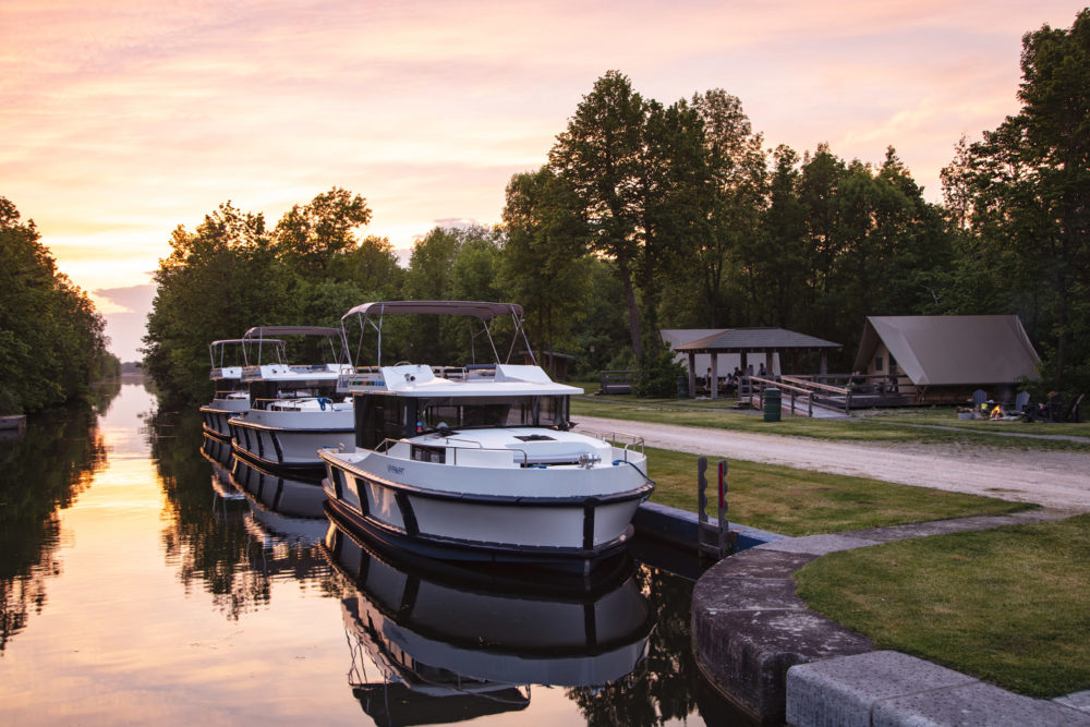 Le Boat Horizon houseboats docked at Beveridge Locks along Tay River near Lower Rideau Lake, Ontario, Canada