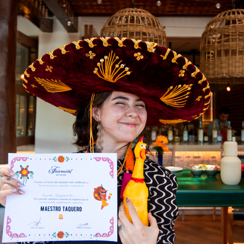 Young girl receives certificate for taco making class at Fairmont Mayakoba
